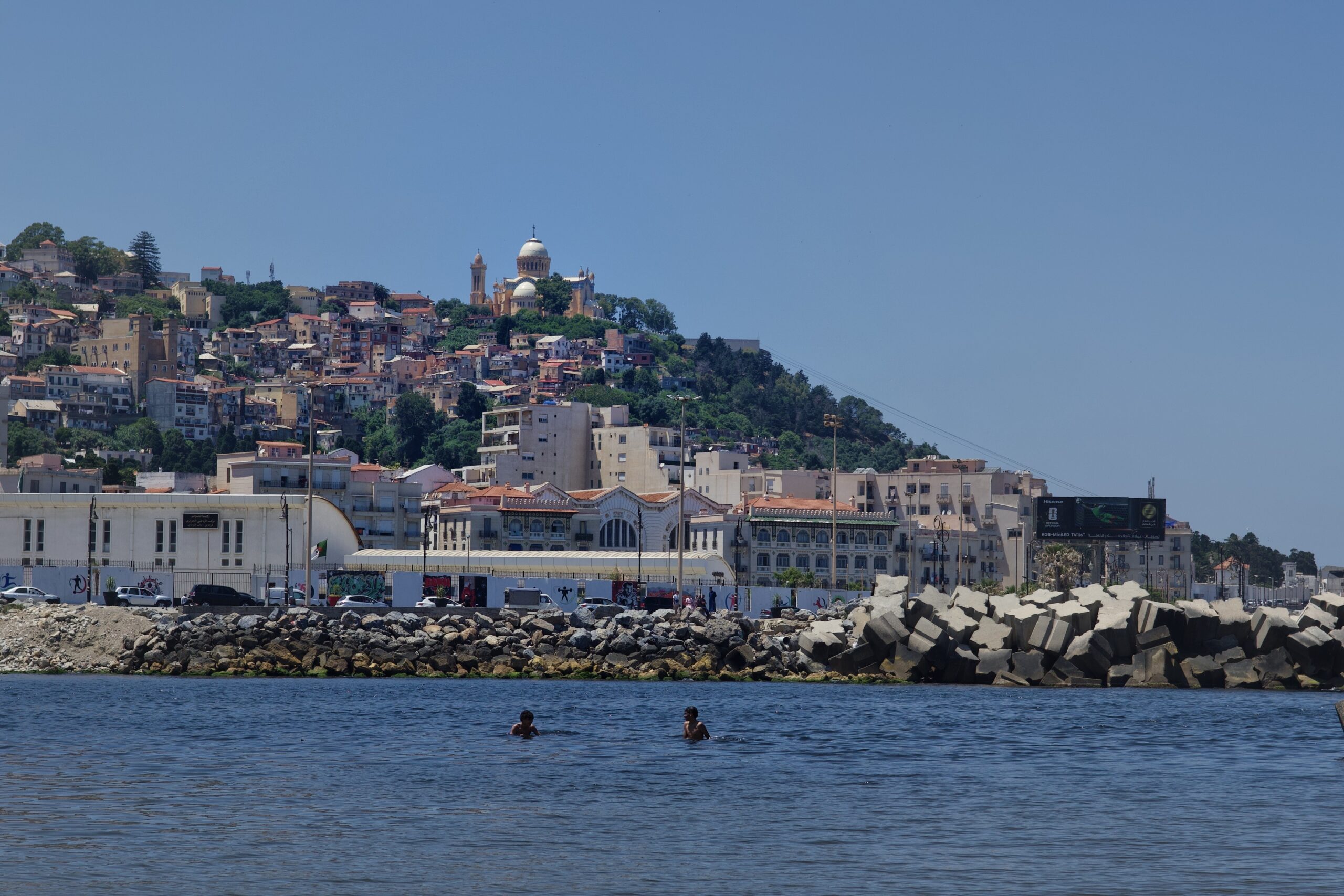 View of Notre_Dame d'Afrique on the hill above Algiers from Plage El Kettani